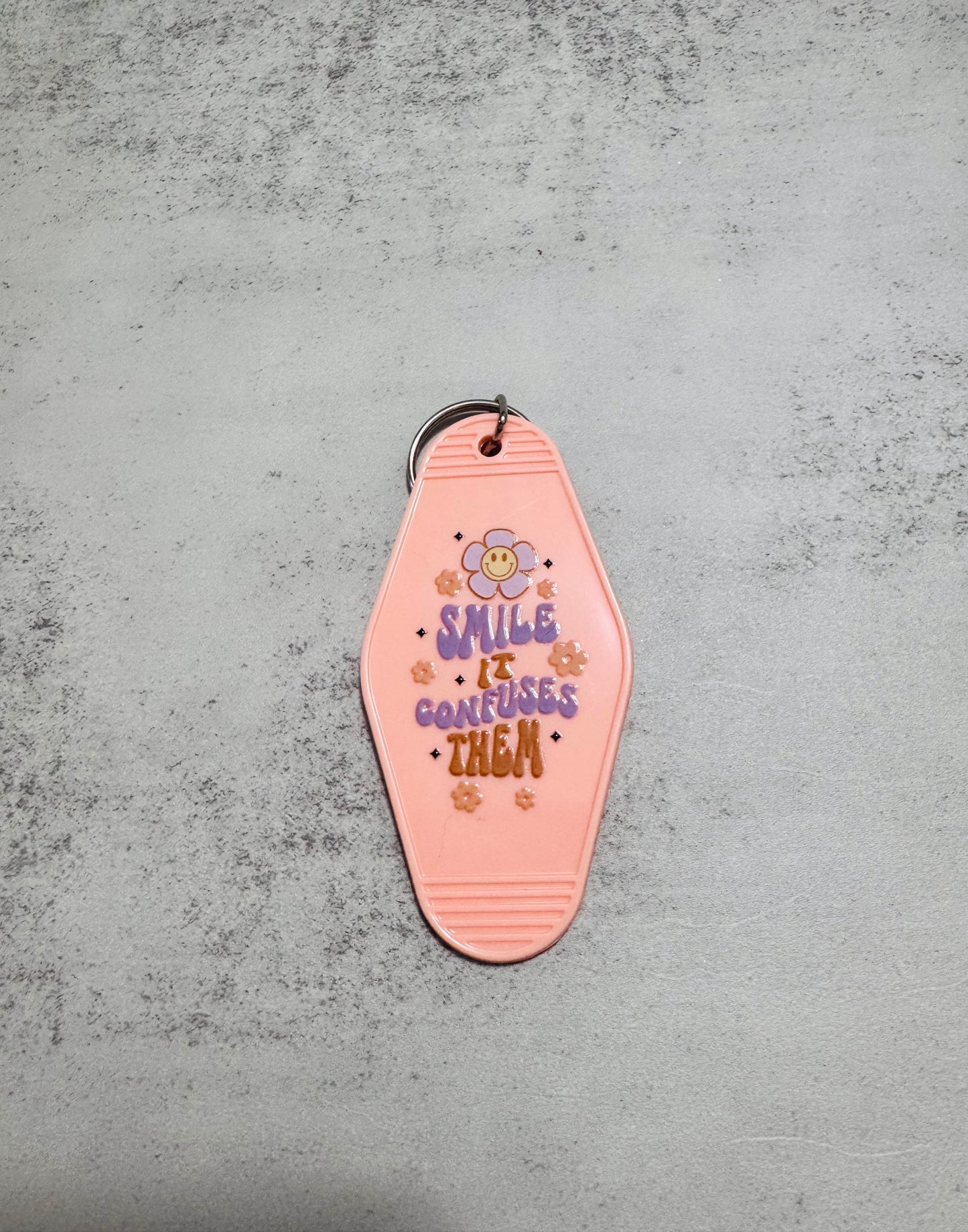 Smile it confuses them Motel Keychain